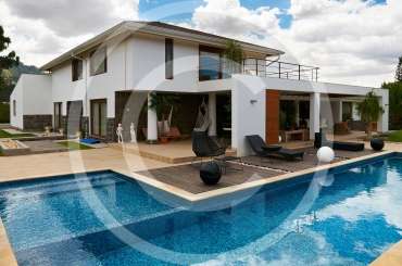 Geometric pool design using brick with gazebo & decorative lighting